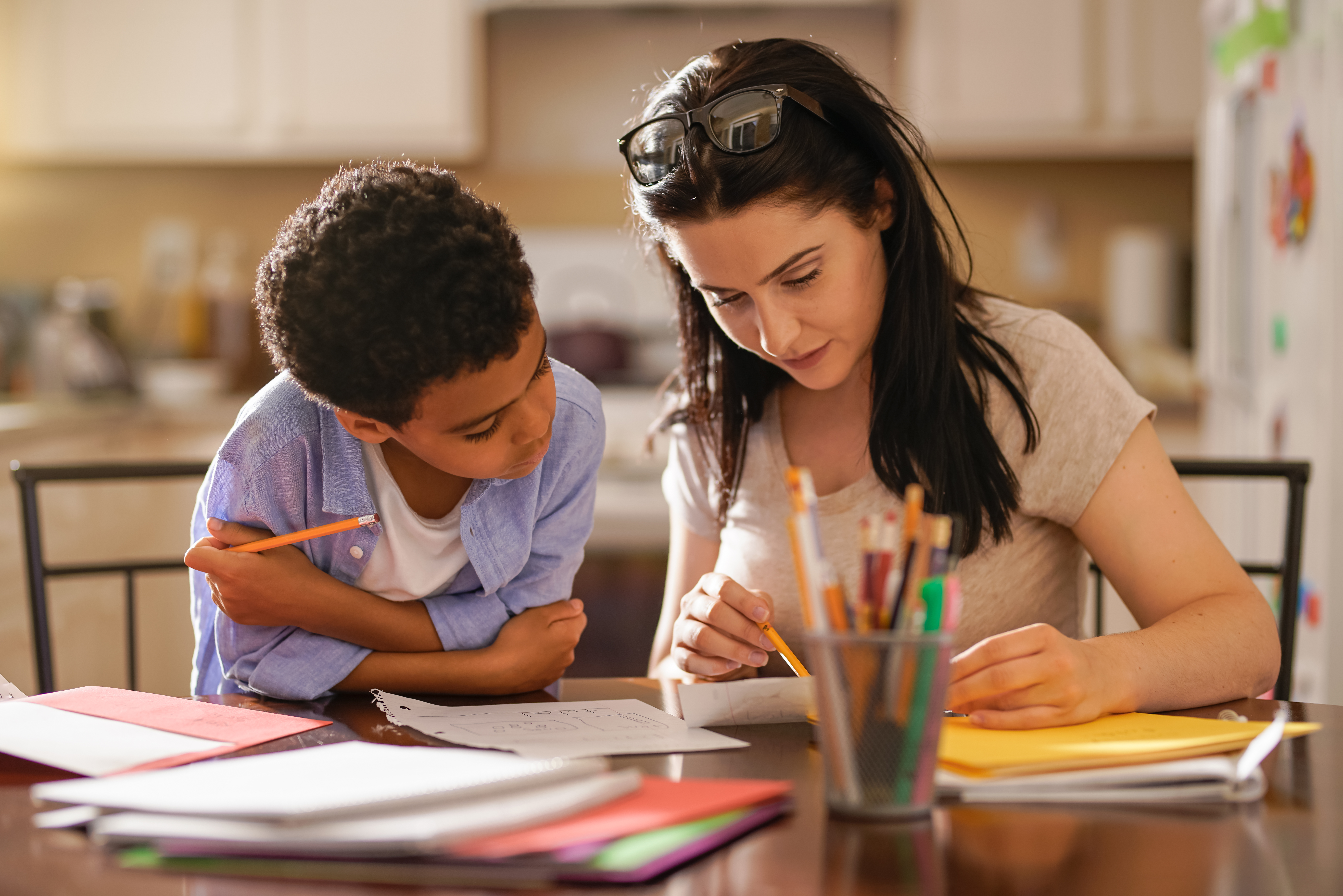 Woman Assisting Son In Doing Homework Woman Assisting Son In Doing Homework